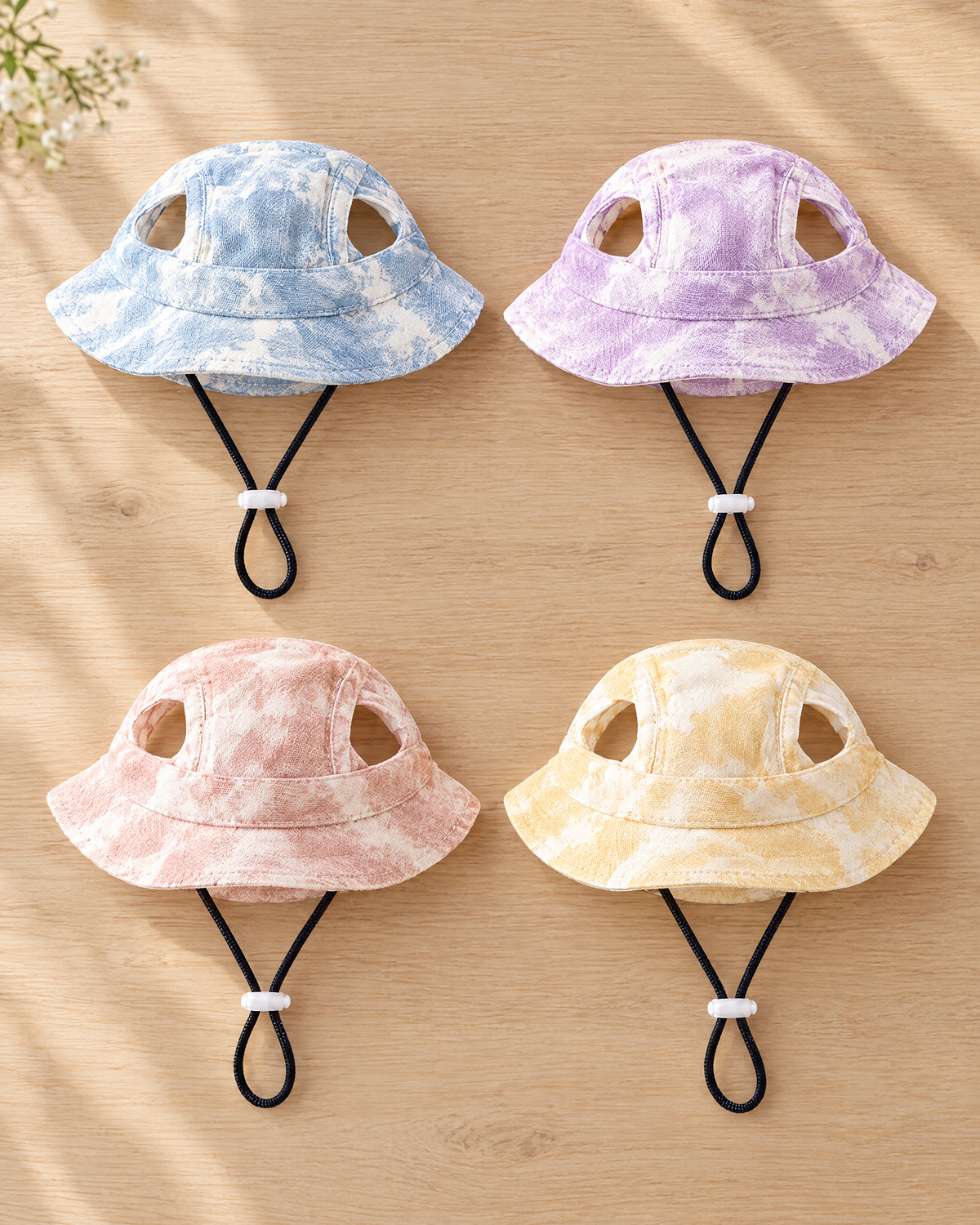 All four colours of the tie-dye dog sun hat: blue, purple, peach and cream yellow