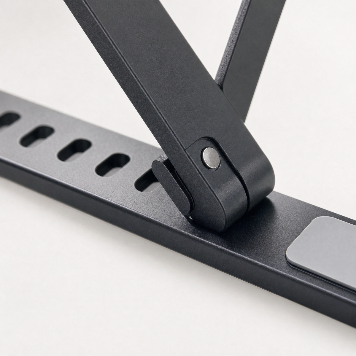 Close detail of the aluminium hinge and the row of height adjustment notches